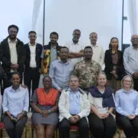 The participants, a diverse mix of men and women, are posed in two rows—one seated and one standing during the launch of Cochrane Ethiopia