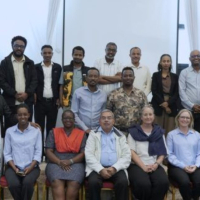 The participants, a diverse mix of men and women, are posed in two rows—one seated and one standing during the launch of Cochrane Ethiopia